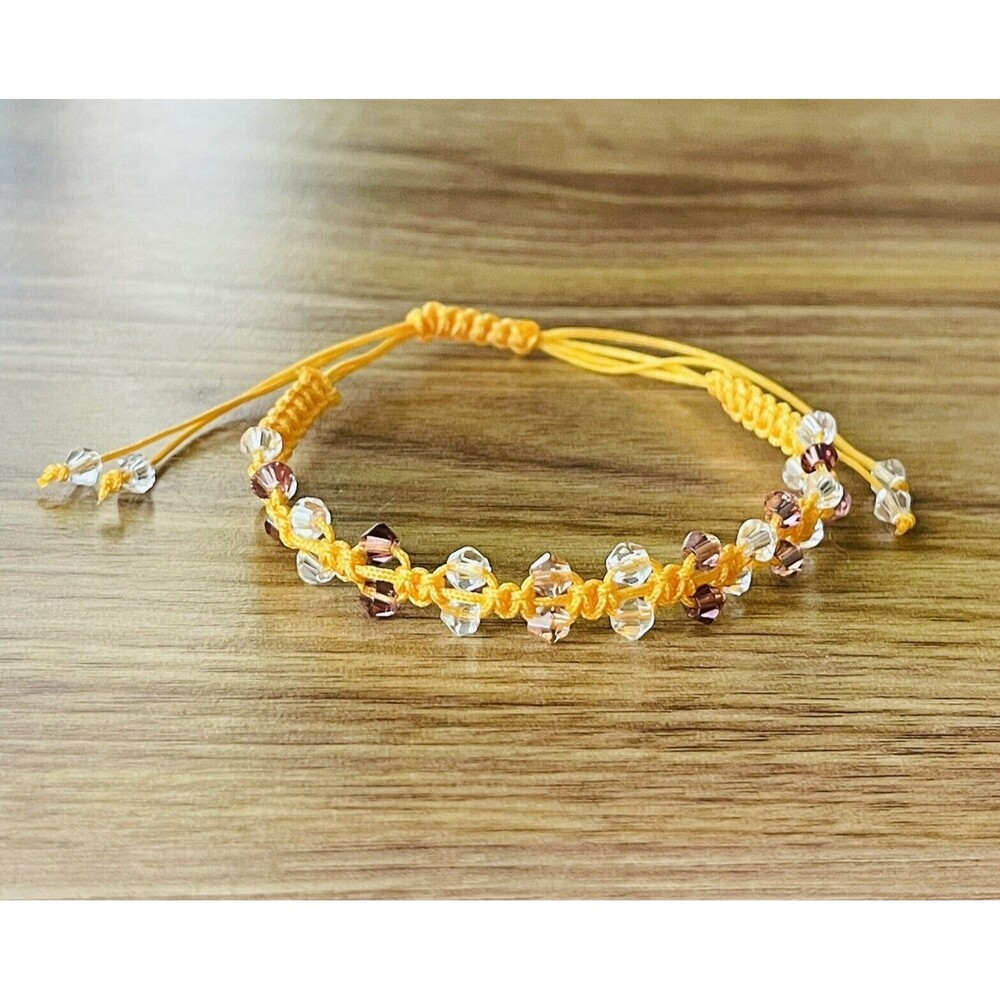 Yellow women's bracelet braided with crystals